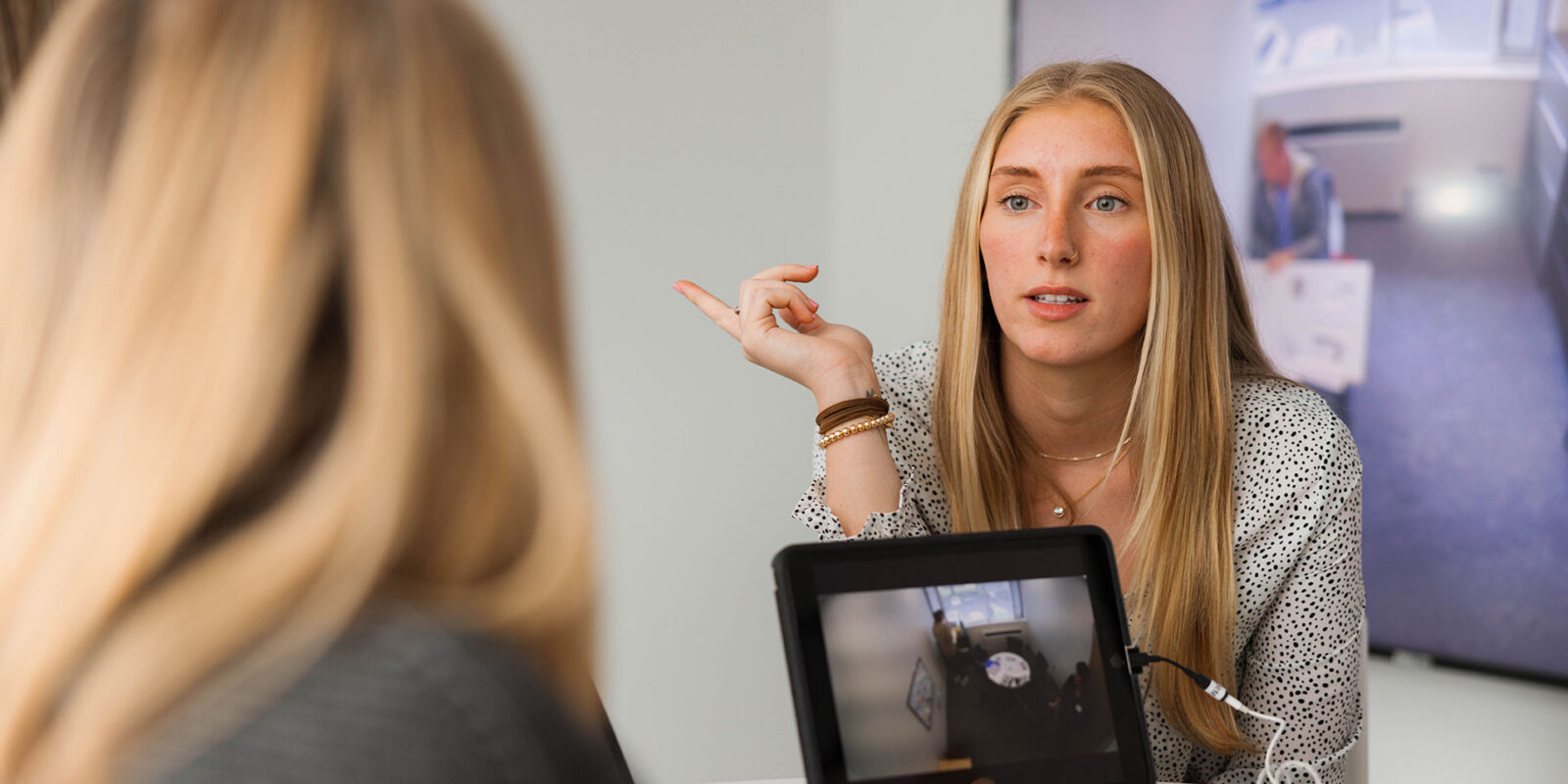 Woman in interview with student