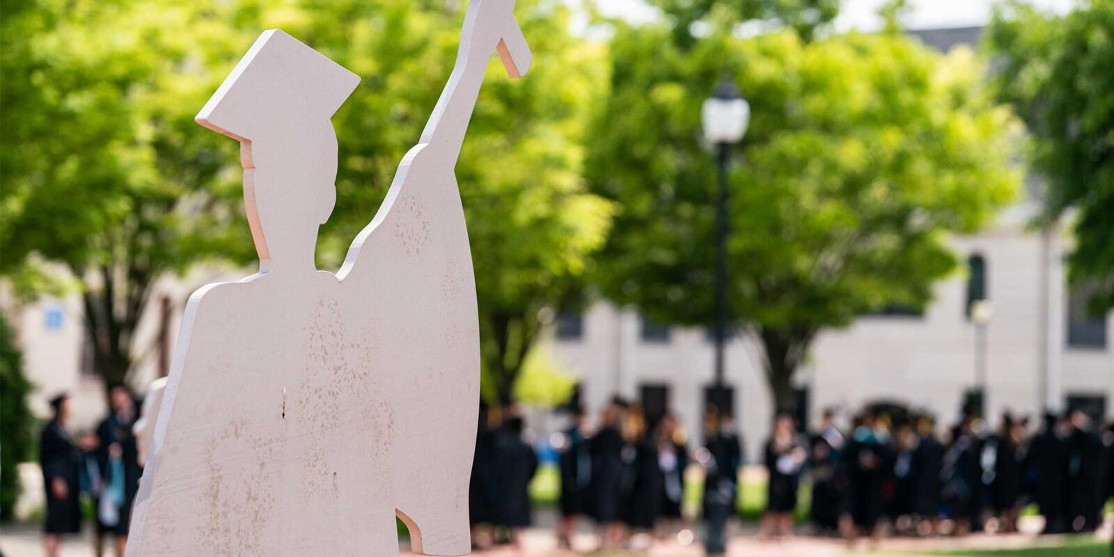 statue of graduate outside university