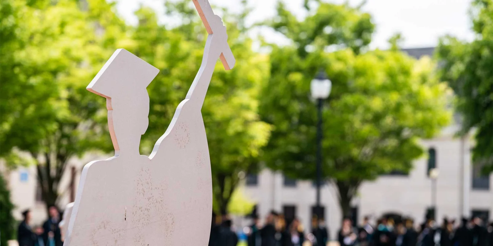 statue of graduate outside university